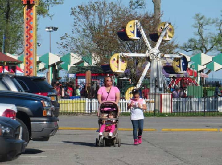 A mother and her two children leave Playland on opening weekend in May 2014. 