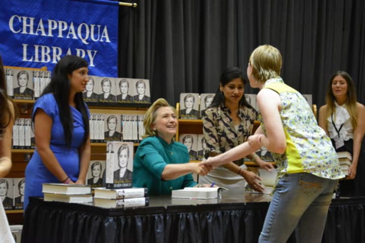 Hillary Clinton gives a handshake during her June 2014 book-signing stop at the Chappaqua Library.