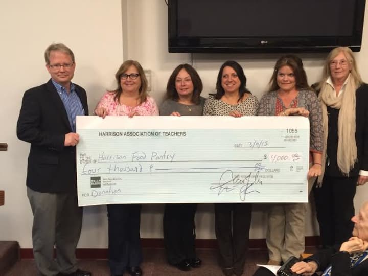 The Harrison Association of Teachers presented a large check to the Harrison Food Pantry.