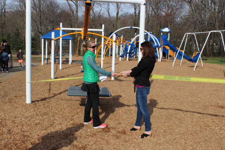 Royle PTO Co-Chairs Shelly Skogslund and Tara Wurm cut the ribbon on the school&#x27;s brand new playground.
