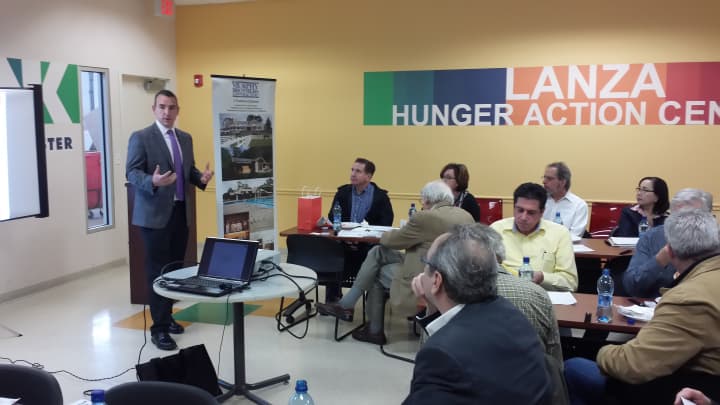 Michael Kelly, sales and marketing manager for PURE Insurance of White Plains, talks to architects and designers at the Food Bank For Westchester.