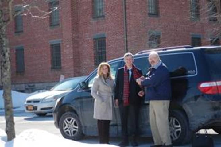Putnam County Executive MaryEllen Odell, left, watches as Thomas Hearn of Maryland presents Veterans Service Agency Director Karl Rohde with the keys to his late fathers Honda Odyssey. 