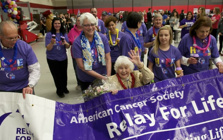 Dorothy Holland, a 50-year cancer survivor, beams as she leads the parade of survivors at Friday&#x27;s Relay for Life at Sacred Heart University in Fairfield.