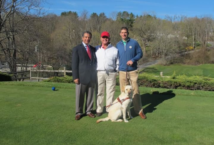 Al Maiolo, center, with Mount Kisco Country Club general manager Hussein Ali, left, head golf pro Chris Case and Guiding Eyes dog Darien.