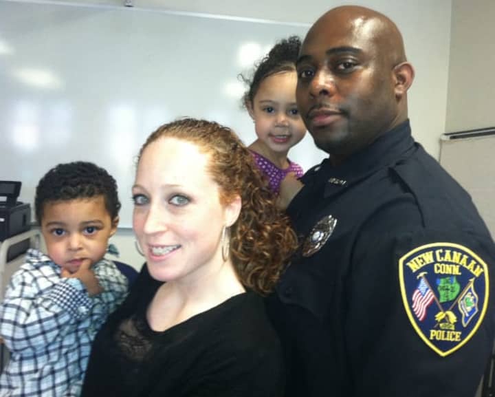 Clinton Jarvis, who was sworn in as a New Canaan Police officer on Tuesday, with his wife, Rachel, and their children, Cameron, at left, and Taylor.