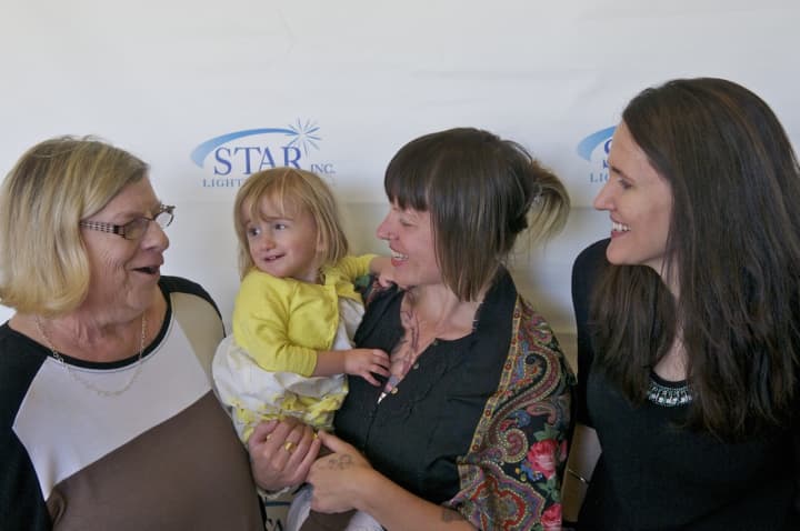 Grace Bennett (left) with Wolf Grace, 2, and mom Kate Bagnati, meet with author Liz Murray (right).
