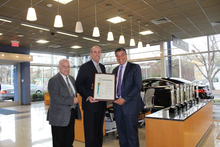 Ronald Tocci, left, director of the Westchester County Veterans Service Agency, and Kevin Plunkett, center, deputy county executive, present Gary Turco, general manager of Mercedes Benz of White Plains, with an award.
