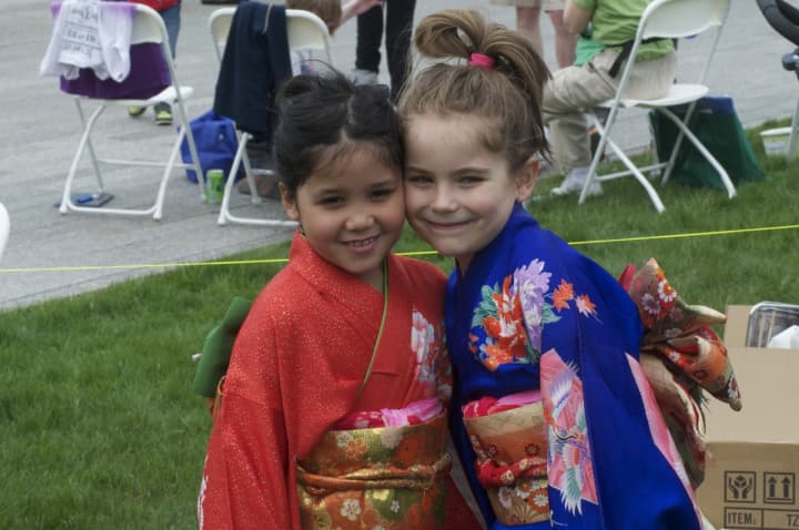 Seven-year-old Jaimie Corpuz (left) and Ava Tarnacki, 6, both of Stamford, in kimonos at the Cherry Blossom Festival in Stamford on Saturday.