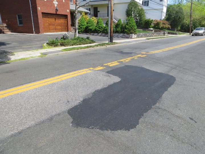 This stretch of Park Aenue in Harrison remained pitted by deep potholes last week .By Tuesday May 12, public works crews had filled them with fresh asphalt. 