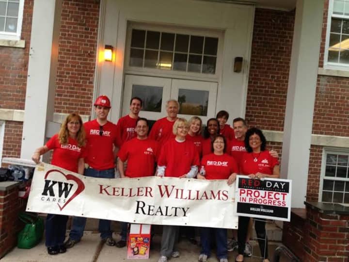 Employees of Keller Williams in Ridgefield celebrate the company&#x27;s Day of Red on May 14.