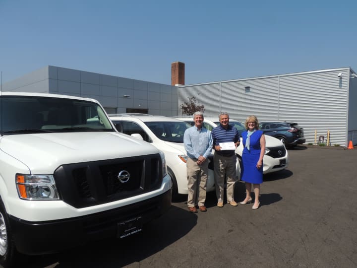 Bill Casale, director of operations of STAR; Paul Miller, president of Miller Nissan in Fairfield; and Katie Banzhaf, executive director of STAR  in front of the new vans.
