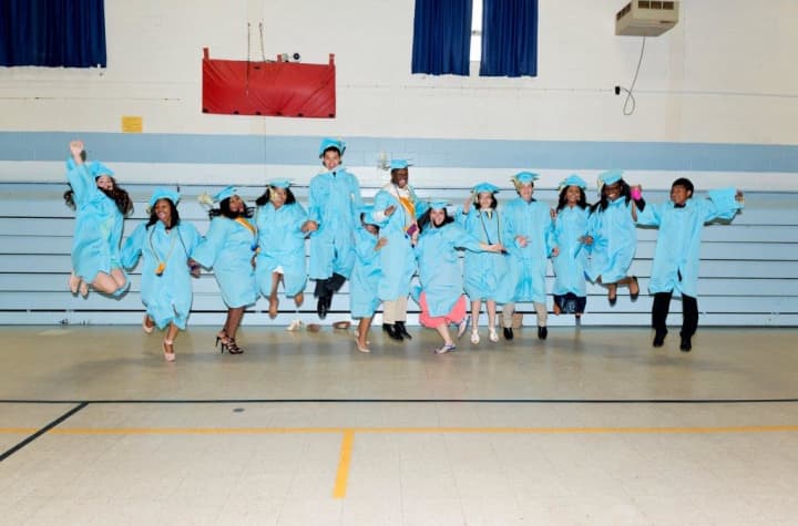 Representatives of Bridgeport&#x27;s Kolbe Cathedral High School Class of 2014 jump for joy as 100 percent pursue higher education, earning $12.2 million in scholarships and financial aid.