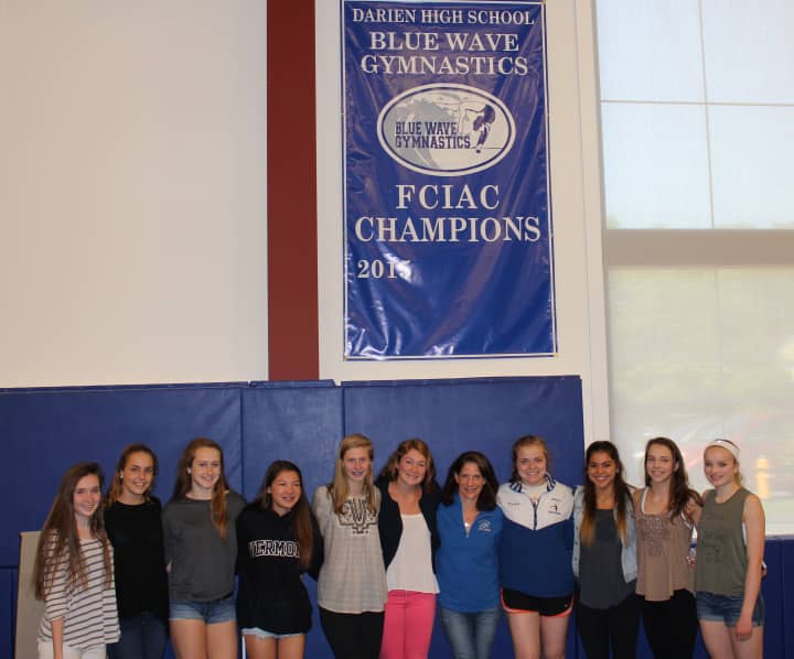 Members of the Darien Blue Wave gymnastics team, which recently won the  the Fairfield County Interscholastic Athletic Conference championship meet.