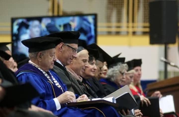 Pace University President Stephen Friedman, left, sits among University faculty at Tuesday&#x27;s ceremony. 