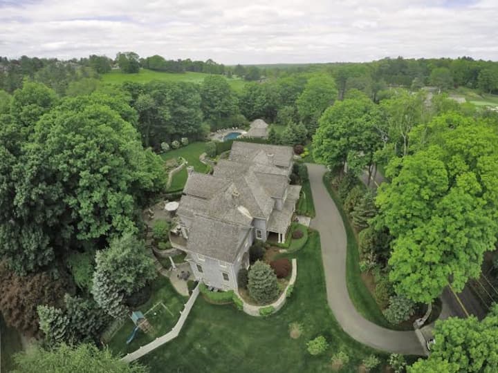 A newly listed home at 64 Old Redding Road in Weston features up-close views of Aspetuck Valley Country Club.