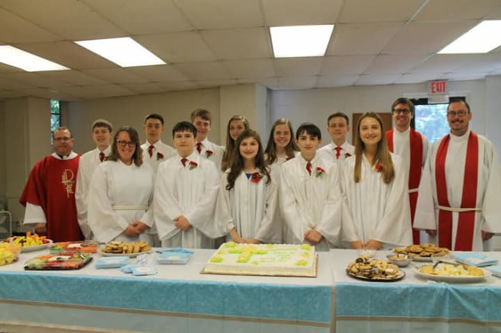 The Rev. Morris Mayer (left); Youth Minister Kate Marino, the Rev. Scott Geminn and the Rev. Dr. Robert Hartwell (right) along with the Village Lutheran Church Confirmation class of 2015
