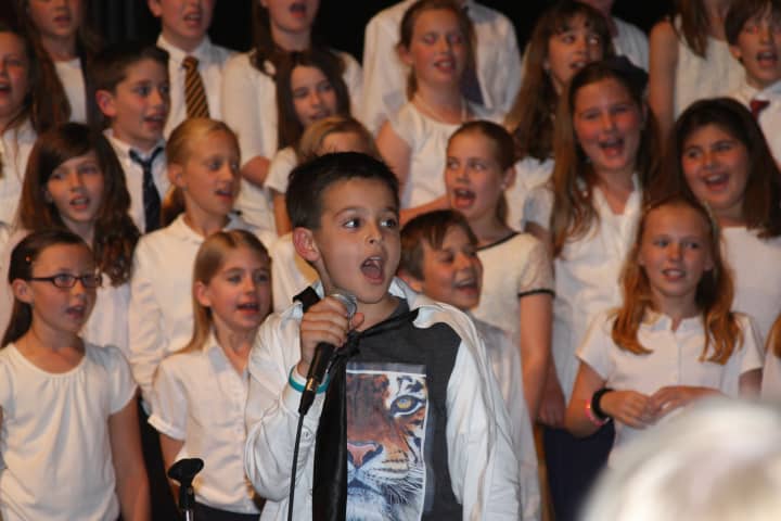 Soloist James Tomasello performs with his peers at Holmes Elementary School&#x27;s spring concert.