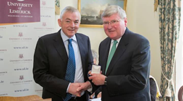 Kevin Conlisk, right, receiving the Presidents Medal from President Don Barry at the University of Limerick in honor of his commitment to the accessibility of higher education and the 34 years of the Rev. John M. Conlisk Irish Scholarship.