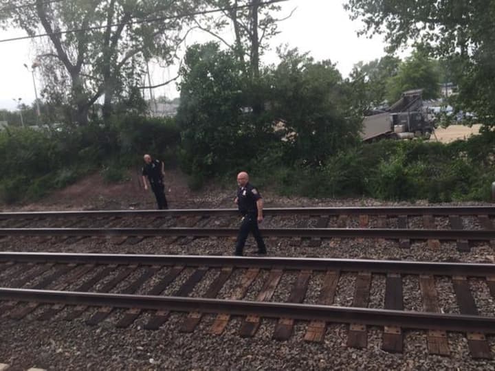 Police on the train tracks just east of the Fairfield Metro station where a man was hit and killed May 27. 