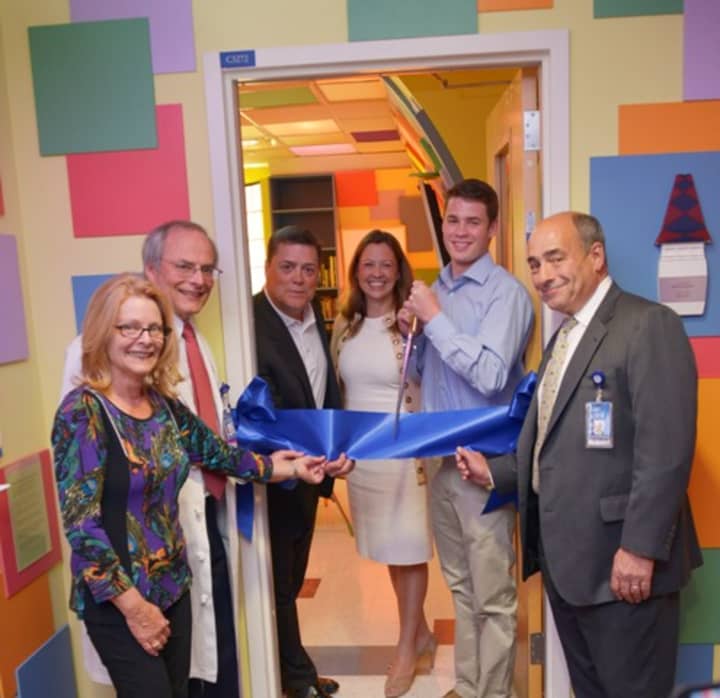 Jackson Krase, second from right, cuts the ribbon on the new Lions Den room at Maria Fareri Children&#x27;s Hospital. 