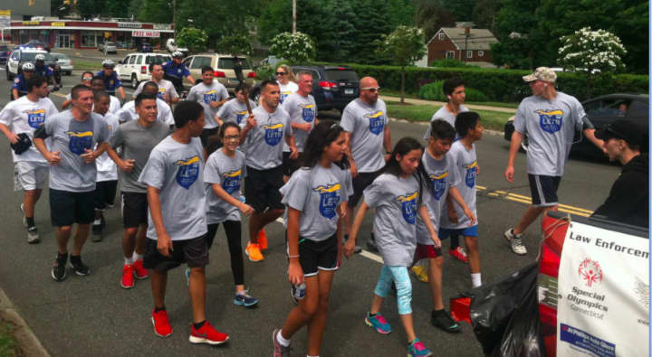Runners in the Norwalk section of the Law Enforcement Torch Run on Friday morning.