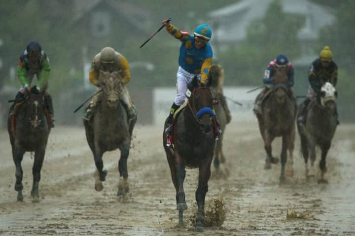 American Pharoah, with jockey Victor Espinoza up, splashes to victory in last month&#x27;s Preakness Stakes.