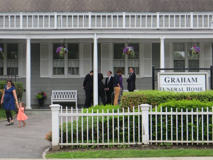 Mourners outside of Graham Funeral Home in Rye on Saturday.