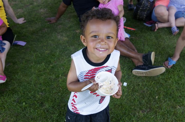 A boy enjoys his cool ice cream on a hot day at the Ice Cream Social at the Lockwood-Mathews Mansion Museum in Norwalk on Sunday.