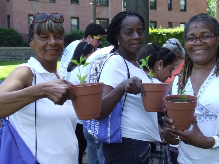 Port Chester residents show off their potted peppers in a recent workshop promoting community gardens.