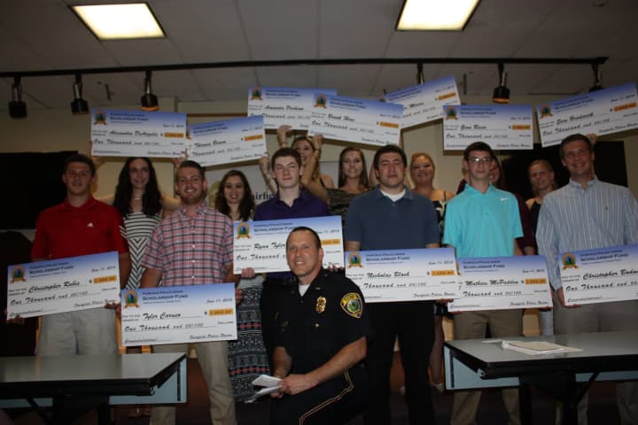 The scholarship recipients show off their checks. 
