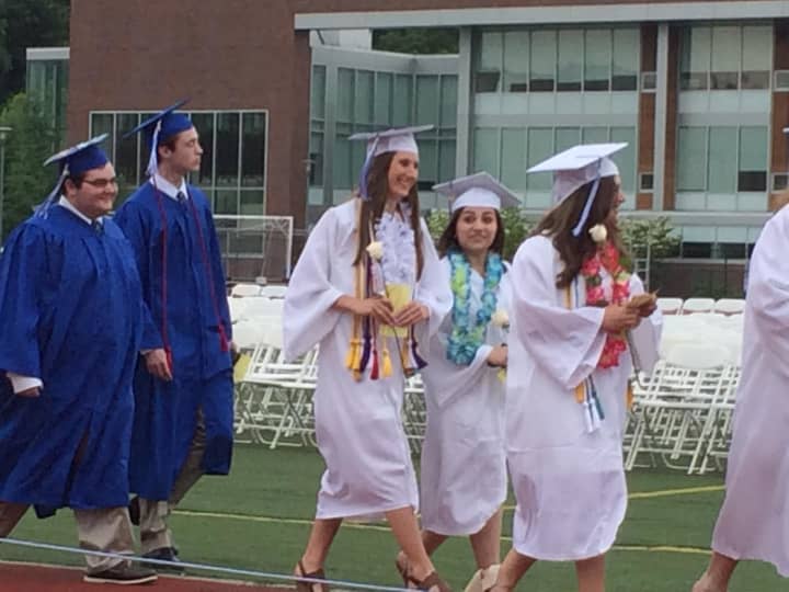 Graduates march onto the field in their processional to start the graduation ceremonies at Fairfield Ludlowe on Wednesday. 