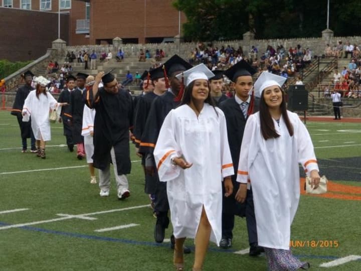 Stamford High School graduates hit the field during commencement exercises at Boyle Stadium in 2015. Connecticut officials announced this week that the state&#x27;s graduation rates hit a record high of 87.2 percent that year.