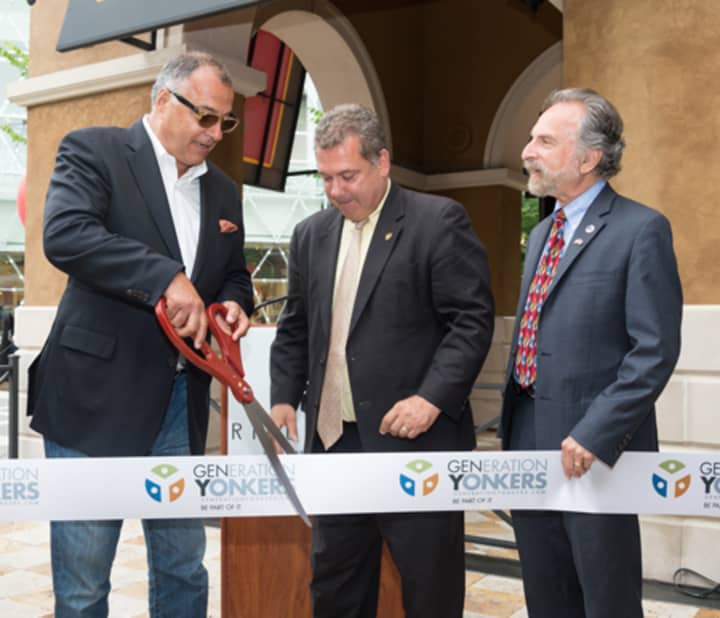 From left, Gillis Poll, Yonkers Mayor Mike Spano and Yonkers Councilman Michael Sabatino cut the ribbon to welcome Angelo&#x27;s to Ridge Hill.