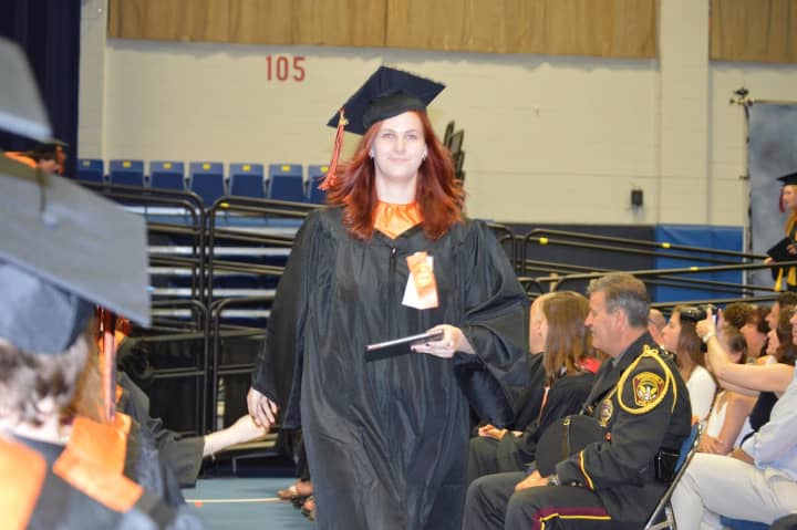 A Ridgefield High graduate accepts a quick congratulations at the commencement on Friday at Western Connecticut State University. 