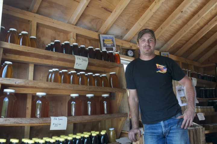 Mike Bruen inside his truck in Brewster, where he offers honey and other bee products.