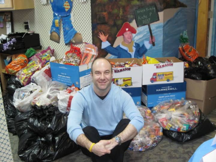 Dr. Benjamin A. Dancygier, of Valley Pediatric Dentistry, sits in front of last years giant pile of donated Halloween candy.