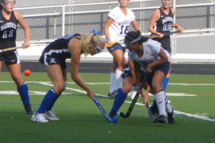 Darien (black), Wilton and six other teams will battle for the Fairfield County field hockey conference championship.