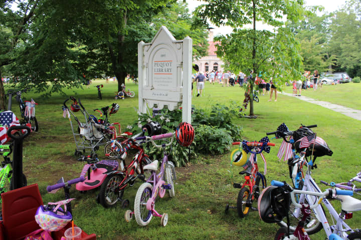 Decorated bikes and trikes of all sizes gather on the Pequot Library&#x27;s Great Lawn after the annual parade from the Five Corners in Southport Village during the 2014 Fourth of July Annual Bike Parade and Lawn Games community event.