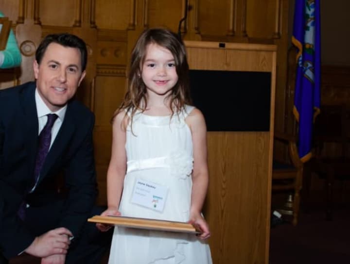 Kindergartener Jayne Visokey won third place at the 11th annual eesmarts student contest. Featured with event host Todd Piro, NBC CT.