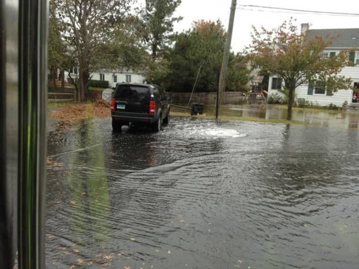 A view of Ralsey Road in Shippan Point in Stamford as water makes its way onto the street. 