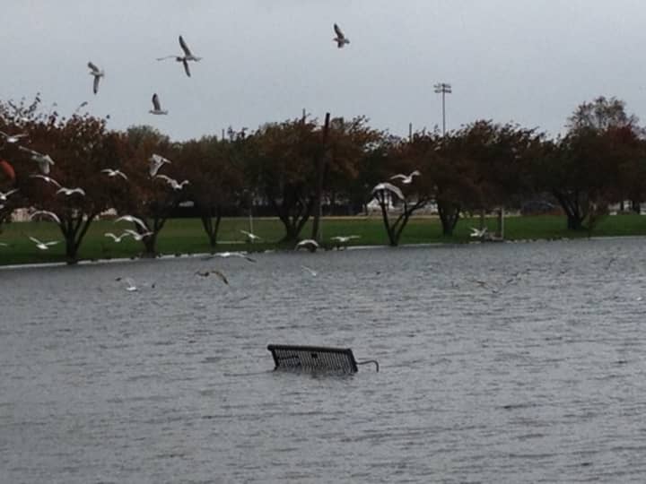 A bench at Harbor Island is partially submerged as Hurricane Sandy approaches the tri-state area.