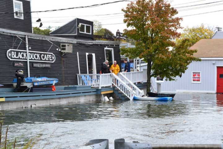 Flood waters reach the Black Duck Cafe on Riverside Avenue Monday following one of three expected high tide cycles. 