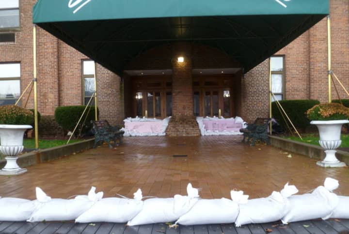 Mayor Mike Spano announced a voluntary evacuation of residences along the Yonkers waterfront, including the Scrimshaw House, which is lined with sandbags.