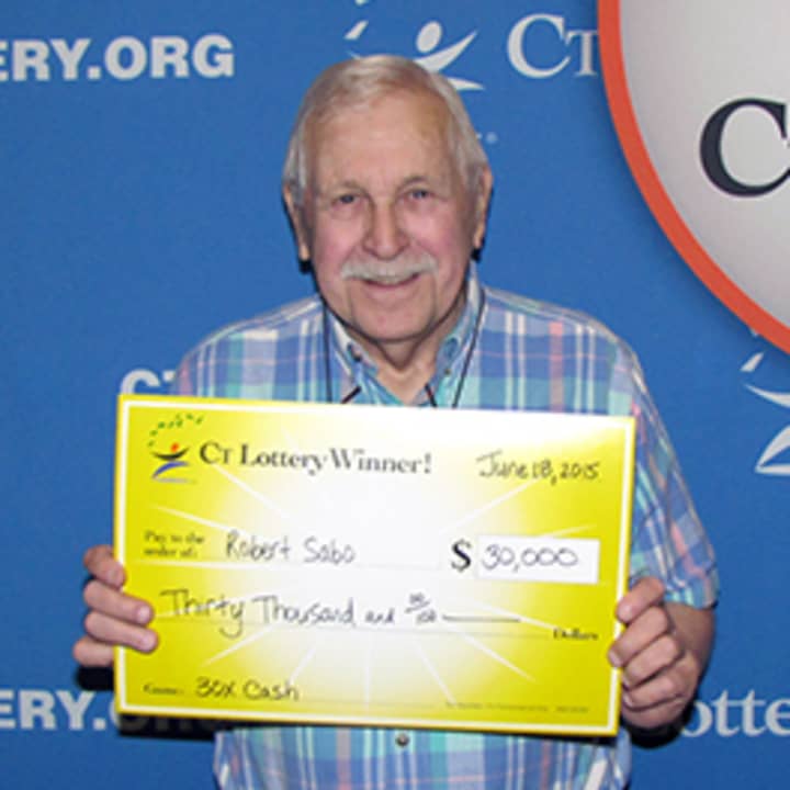 Bob Sabo of Easton shows off his $30,000 check from the Connecticut Lottery. 