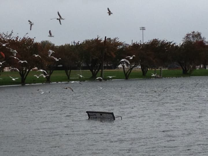 A bench at Harbor Island is partially submerged as Hurricane Sandy approaches the tri-state area.