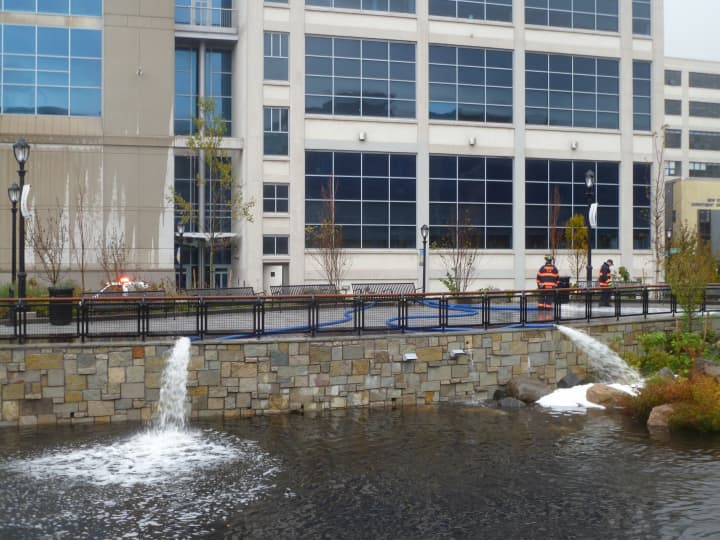 Yonkers firefighters pump water from the Riverfront Library and Board of Education building Tuesday morning after a storm surge flooded the basement Monday night.