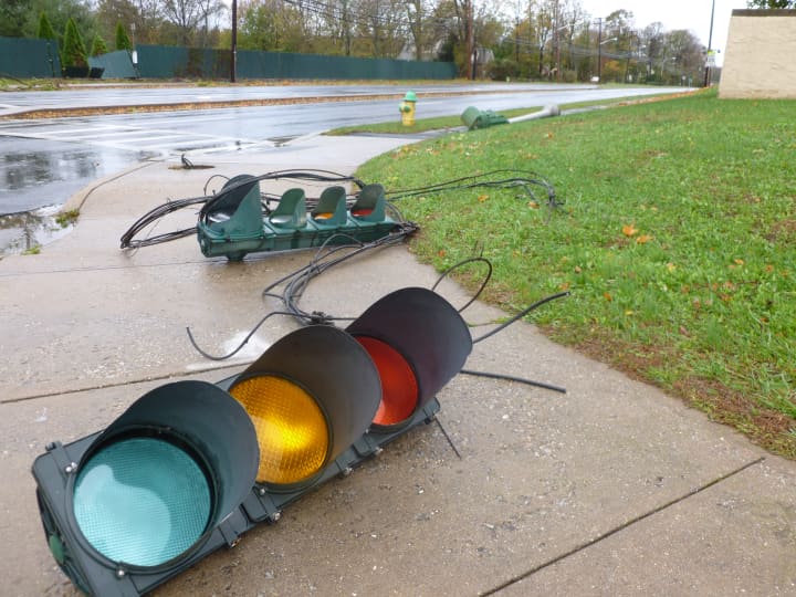 Three traffic lights at the White Plains High School entrance lay on the ground.