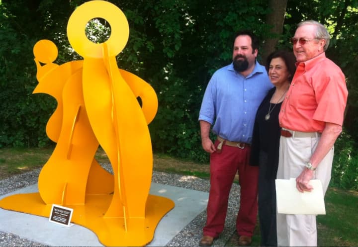 Carole Eisner, center, a sculptor and artist, with Wilton First Selectman Bill Brennan, at right, and Jeff Meuller, gallery director at Silver Mines Arts Center, at the unveiling of Eisner&#x27;s welded metal sculpture, &quot;Konnected.&quot; 
