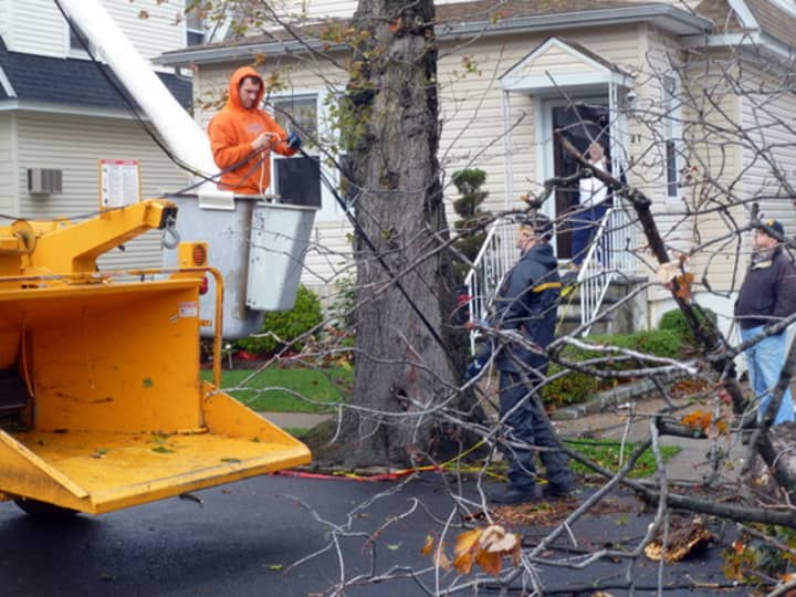 Crews from Yonkers Parks Department tend to a fallen tree and electrical wires Tuesday on Clayton Place, near Yonkers Avenue. 