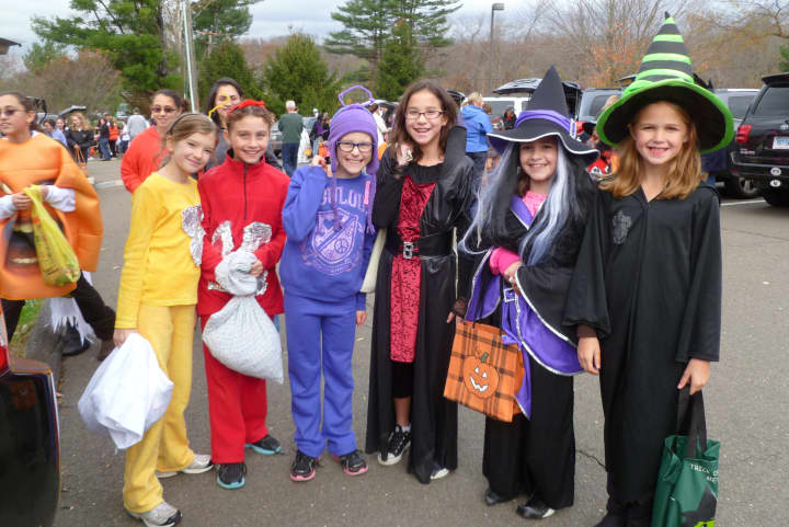 These girls, dressed as Teletubbies and witches, racked up on candy during Wilton&#x27;s Trunk or Treat at Cider Mill School.
